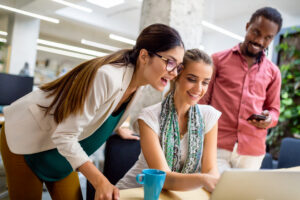 Two seasoned professionals helping a sales intern.