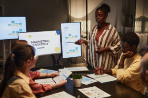 Female professional presenting tailored marketing strategies to her team