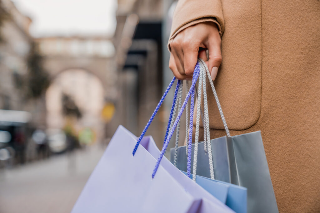 A close-up of a woman with shopping bags, representing a clear buying signal.